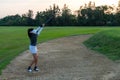 Golfer sport course golf ball fairway.ÃÂ  People lifestyle woman playing game golf and hitting out of sand trap go on green grass Royalty Free Stock Photo